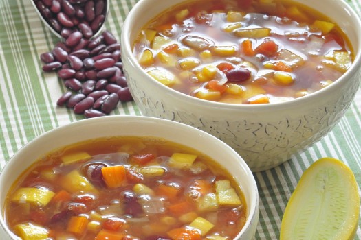 Two bowls of vegetable and bean soup.