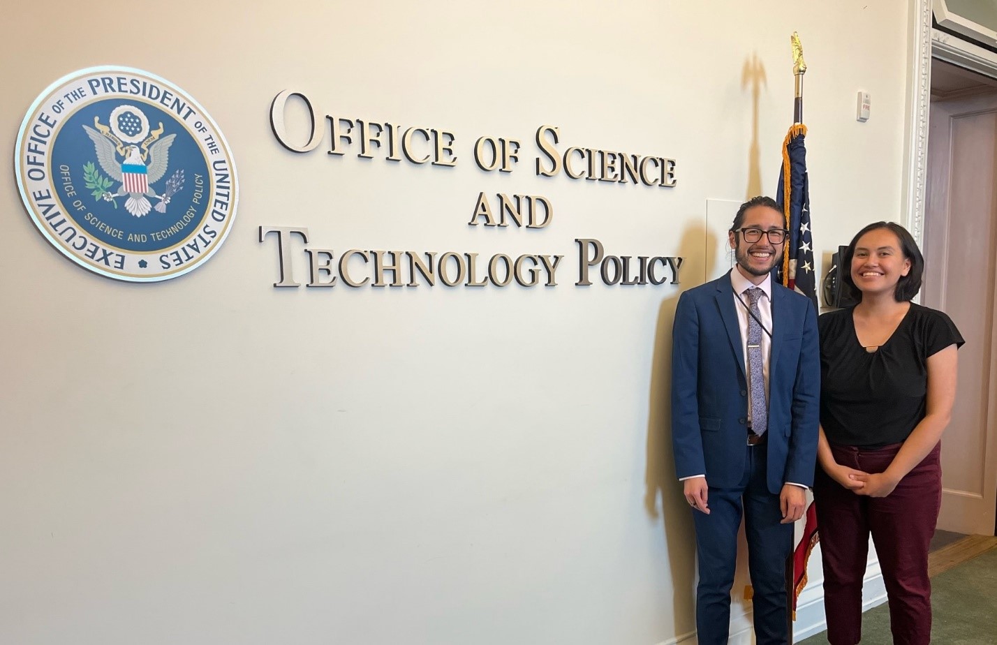 Haley Case-Scott (right) and Julian Reyes (left) in 2023 beside the OSTP sign