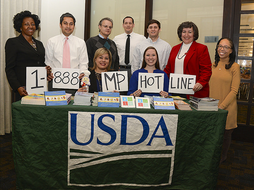 USDA Food Safety Education staff showing the Meat and Poultry Hotline number
