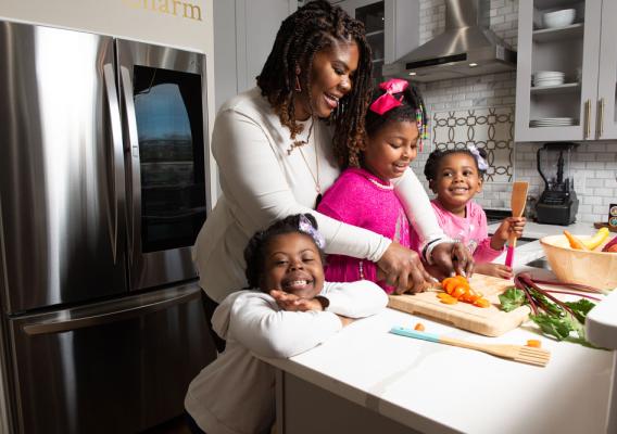 Dr. Cotwright and her three daughters prepare a healthy meal in the kitchen