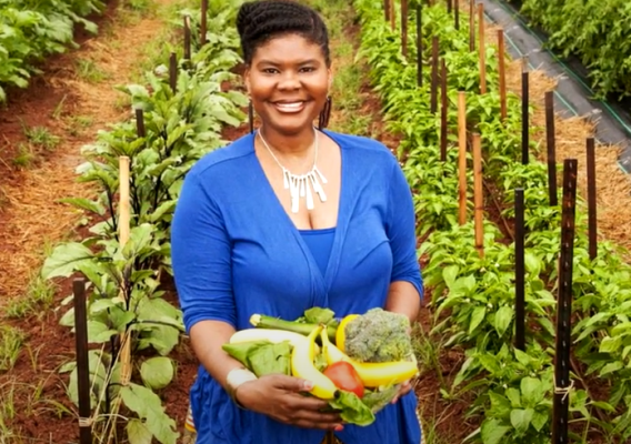Dr. Caree Cotwright, FNS Director of Nutrition Security and Health Equity, collecting fresh produce from a farm