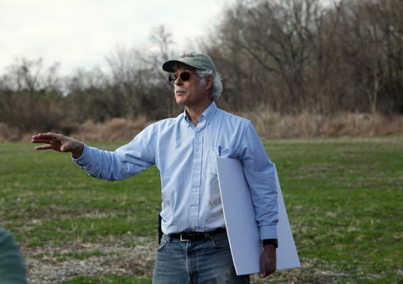 Skip Hyberg, Senior Economist, USDA Farm Service Agency, standing in front of an edge of field conservation practice