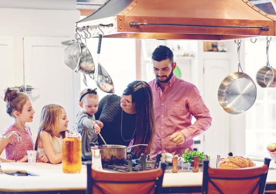 Family in kitchen preparing holiday meal