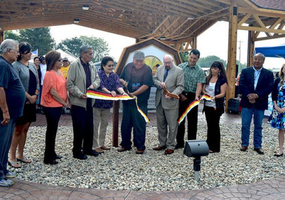 U.S. Dept. of Agriculture Rural Development State Director for Michigan James J. Turner (fifth from right) cutting the ribbon for the Mt. Pleasant Native Farmers Market with Saginaw Chippewa Indian Tribal Chief Steve Pego