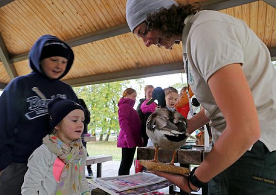 As the traveling Forest Service representative, Teresa Butel helped facilitate the migration station by talking to students about different native bird species (Photo Credit: Julia Schwitzer, Wilderness Inquiry). 