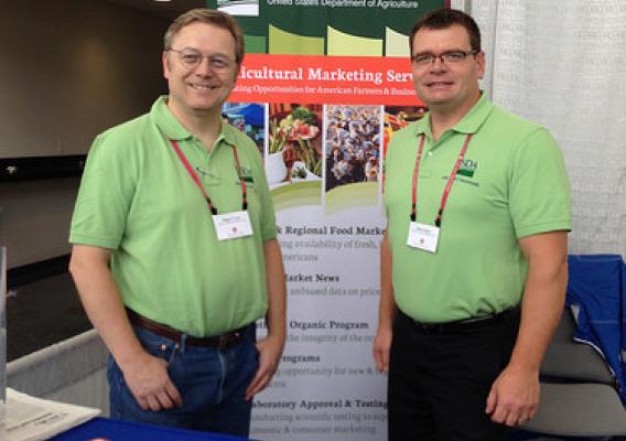 USDA Dairy Program’s Roger Cryan, Director of the Economics Division (left), and Butch Speth, National Supervisor of Dairy Market News, answered questions and spoke with stakeholders at the 2014 World Dairy Expo in Madison, Wisconsin.