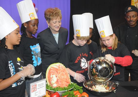 Dr. Janey Thornton, USDA Deputy Under Secretary for the Food, Nutrition and Consumer Services (center) watches as Metrowest Elementary School and Wolf Lake Elementary School student chefs cook their recipes during the Chefs Move to Schools event, Orlando, Fla. (USDA photo by Debbie Smoot)