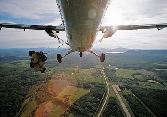 A smokejumper exits a plane. (US Forest Service photo)