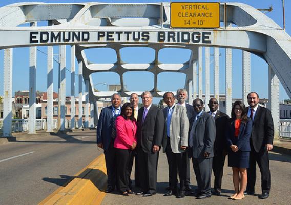 Secretary Tom Vilsack, Congresswoman Terri Sewell and Selma Mayor George Evans along with USDA State Directors and local officials at the Edmund Pettus Bridge in Selma, Ala