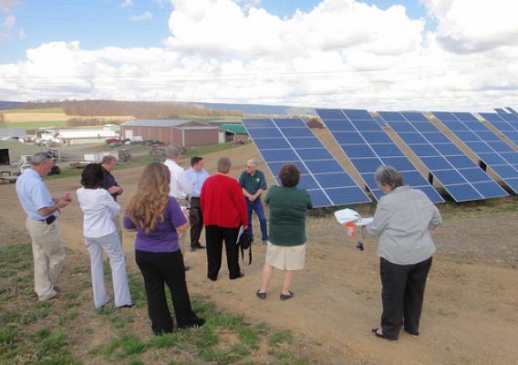 David Fink, owner of Heidel Hollow Farm, described the farm’s energy savings from the 896 panel solar array funded by USDA Rural Development to USDA officials and others gathered at his farm.