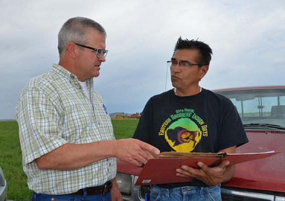 Chuck Petersen, NRCS rangeland management specialist (left), and Reggie Premo, Shoshone-Paiute Tribal member, discuss future conservation plans on Premo’s ranch located on the Duck Valley Reservation in Nevada. USDA photo.