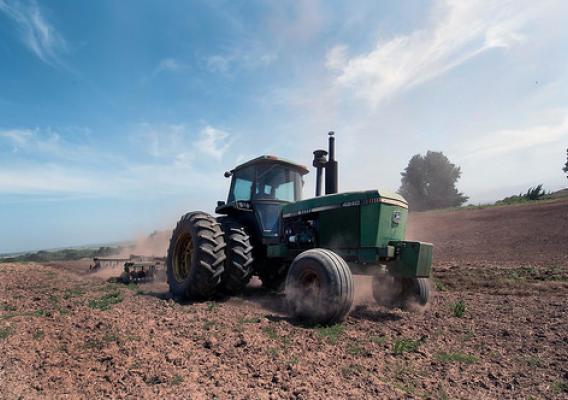 A tractor turns the cover crop into the soil in preparation for planting at Leafy Greens, a farm in the Salinas Valley of California. USDA Photo by Lance Cheung.