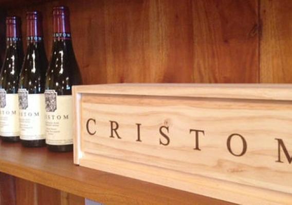Cristom wine bottles on a shelf