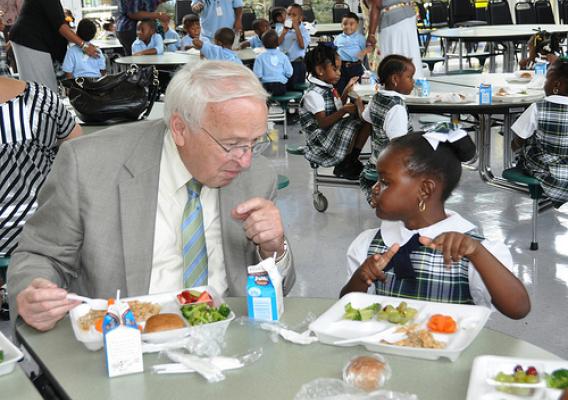 Under Secretary for Food, Nutrition, and Consumer Services Kevin Concannon sharing a healthy lunch with a kindergarten student at Mahalia Jackson Elementary School