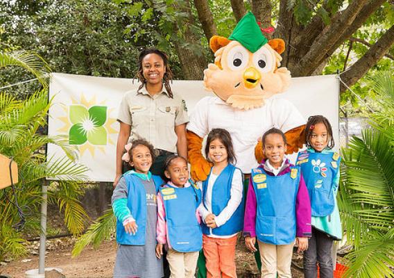 A Forest Service employee, along with Woodsy Owl, pose with kids from the Girl Scott’s Daisy program during National Public Lands Day (Photo Credit: US Forest Service.)