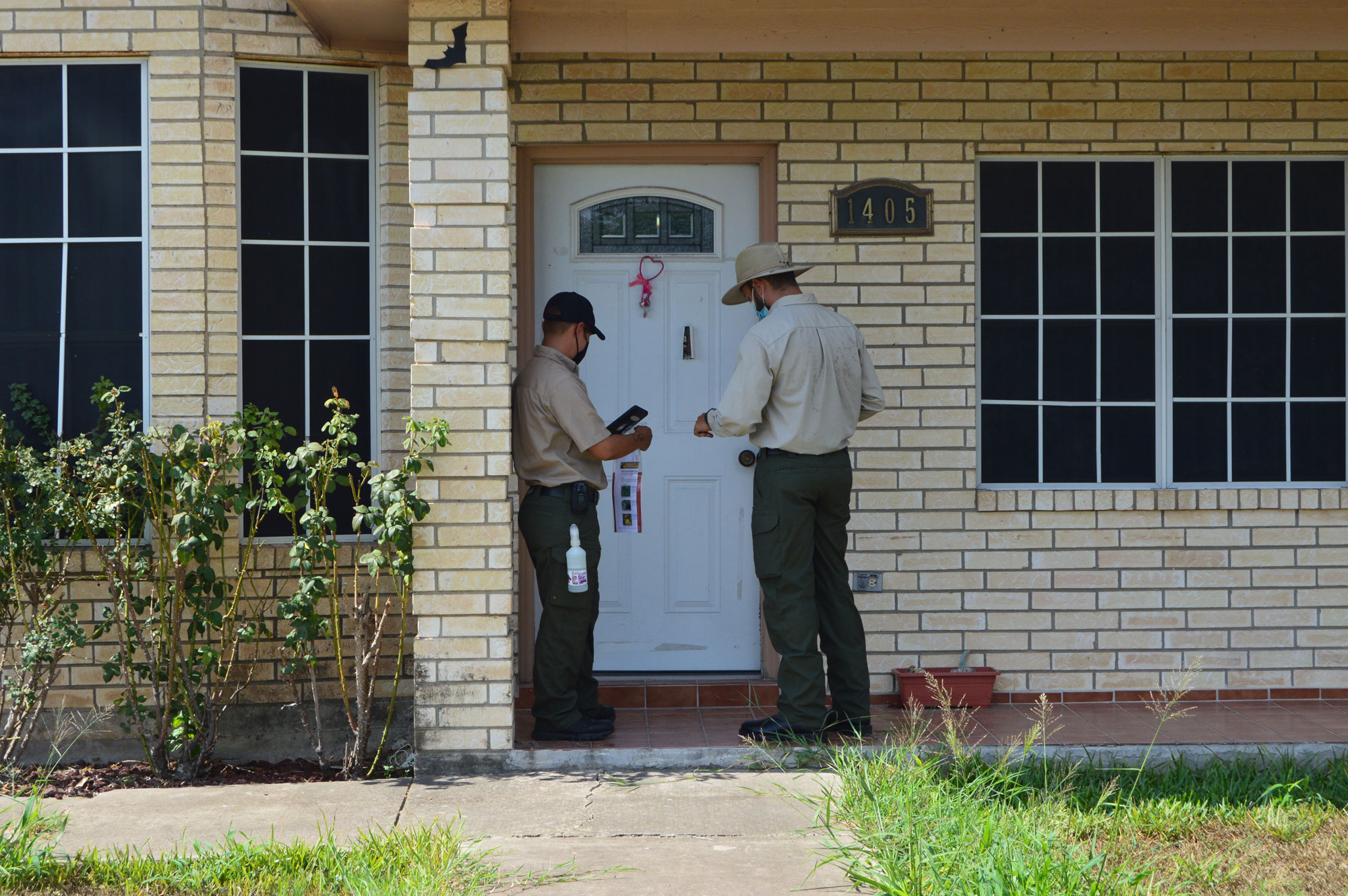 APHIS CHRP inspectors Juan Rodriguez and Eva Flores arrive to evaluate backyard citrus trees in a Pharr, Texas community
