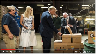 President Trump and others checking the food boxes