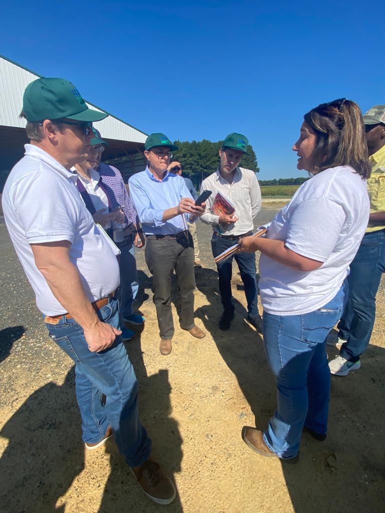 Members of a South America delegation circle around and discuss of the practices they learned about at Hutchison Brothers Farm