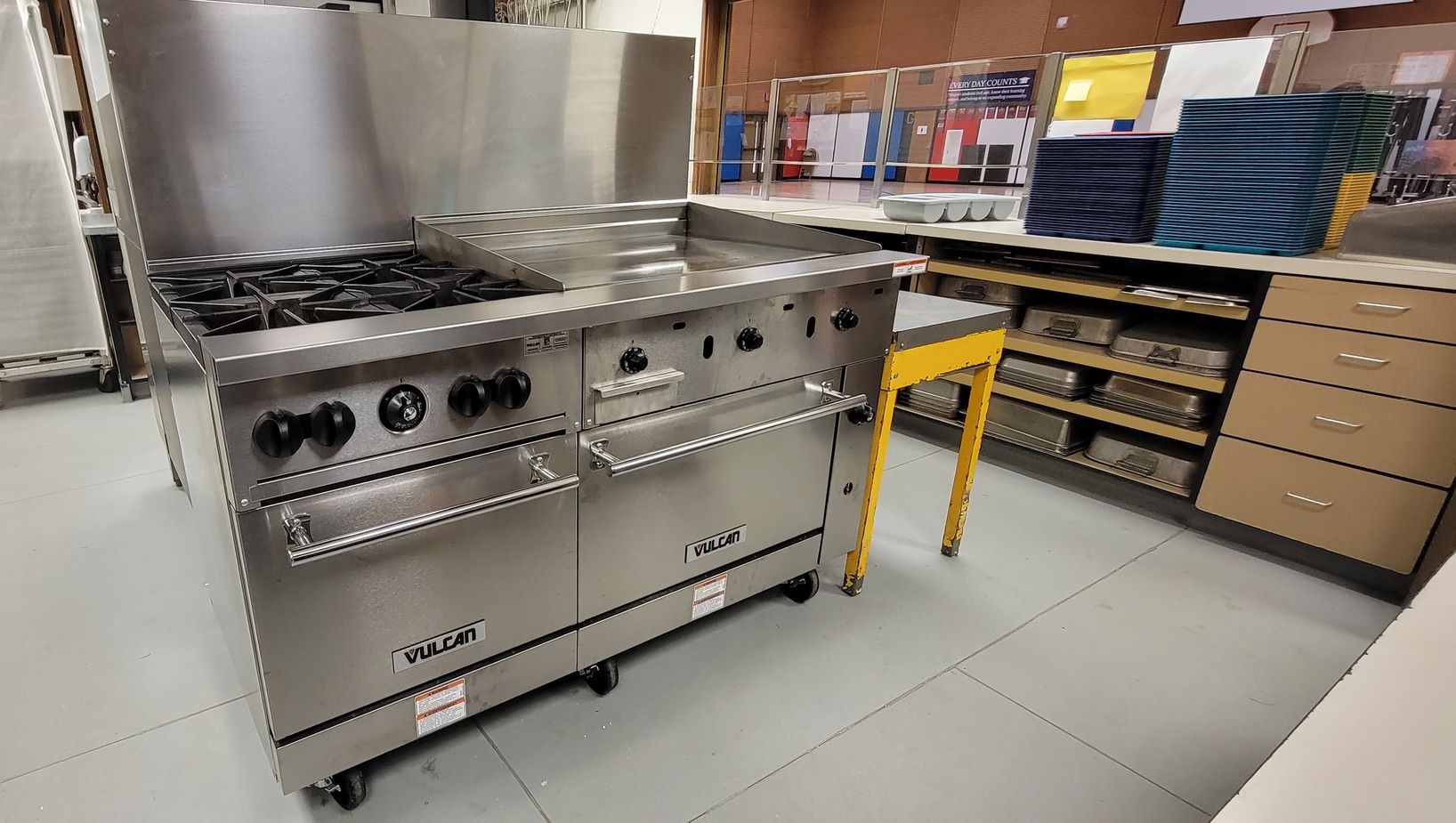 One industrial sized kitchen equipment of four burners with griddle and two ovens