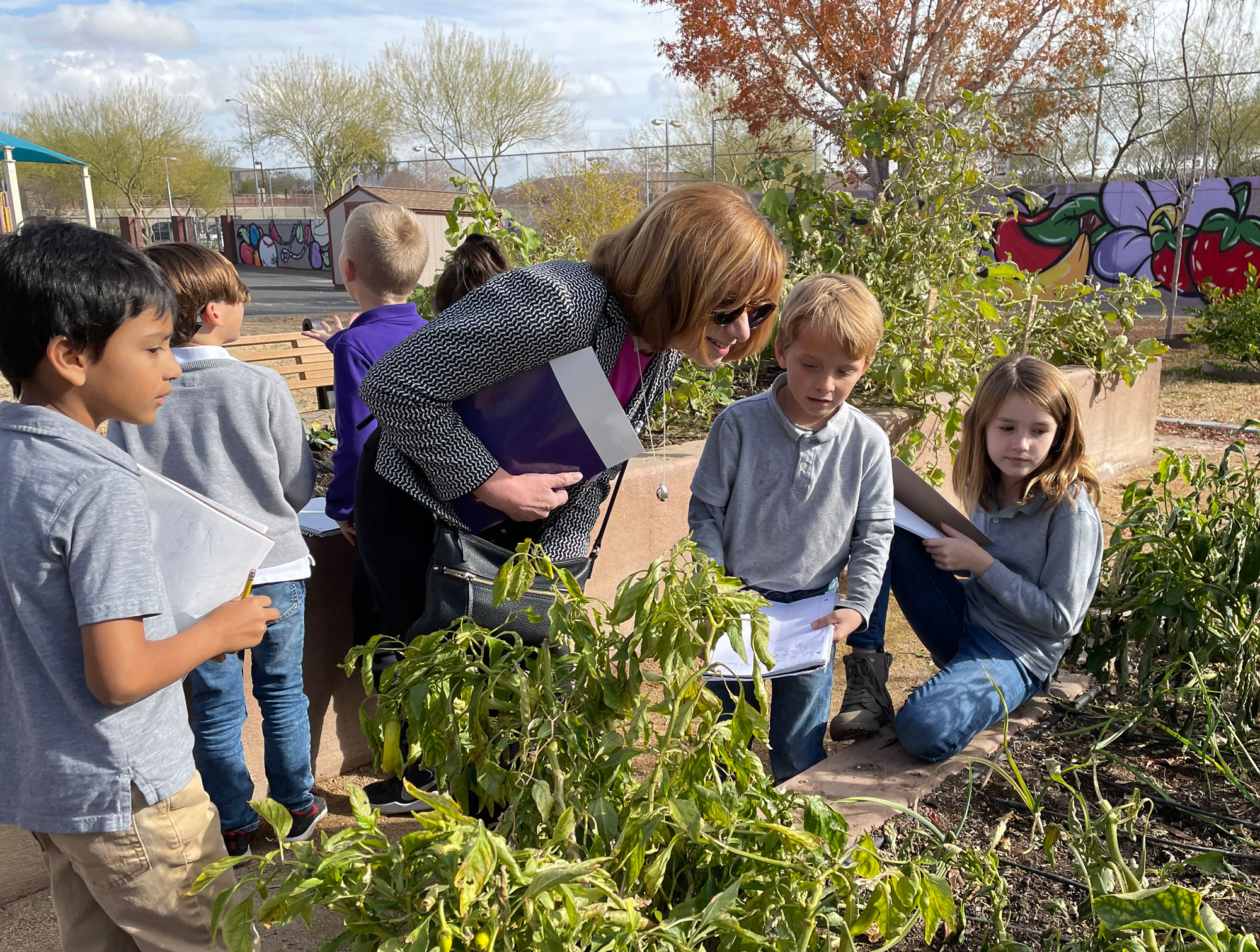Food and Nutrition Service Administrator Cindy Long and kids overlook a garden in McCaw STEAM Academy located in Las Vegas, Nevada