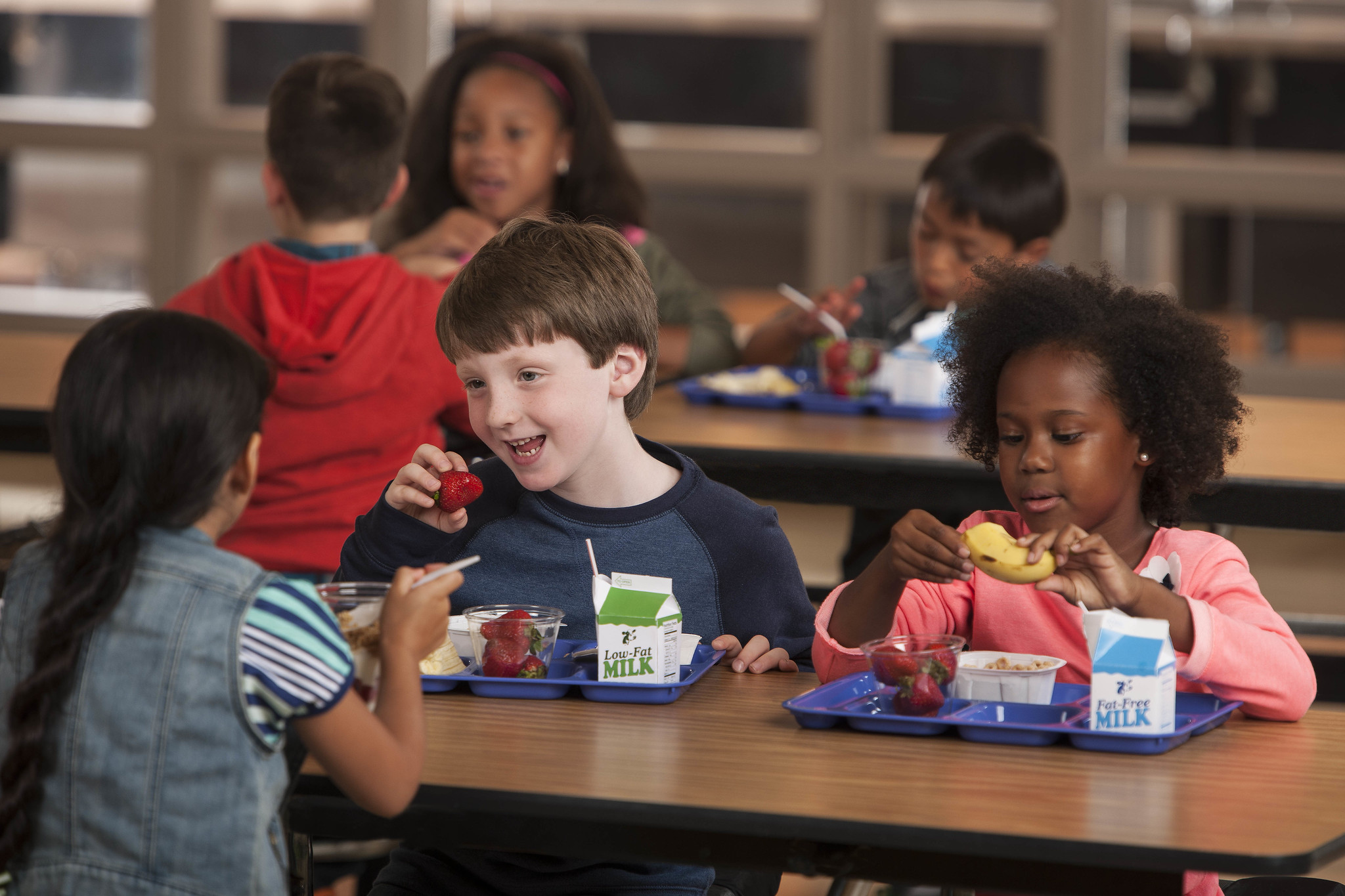 Elementary school students eating school breakfast in the cafeteria
