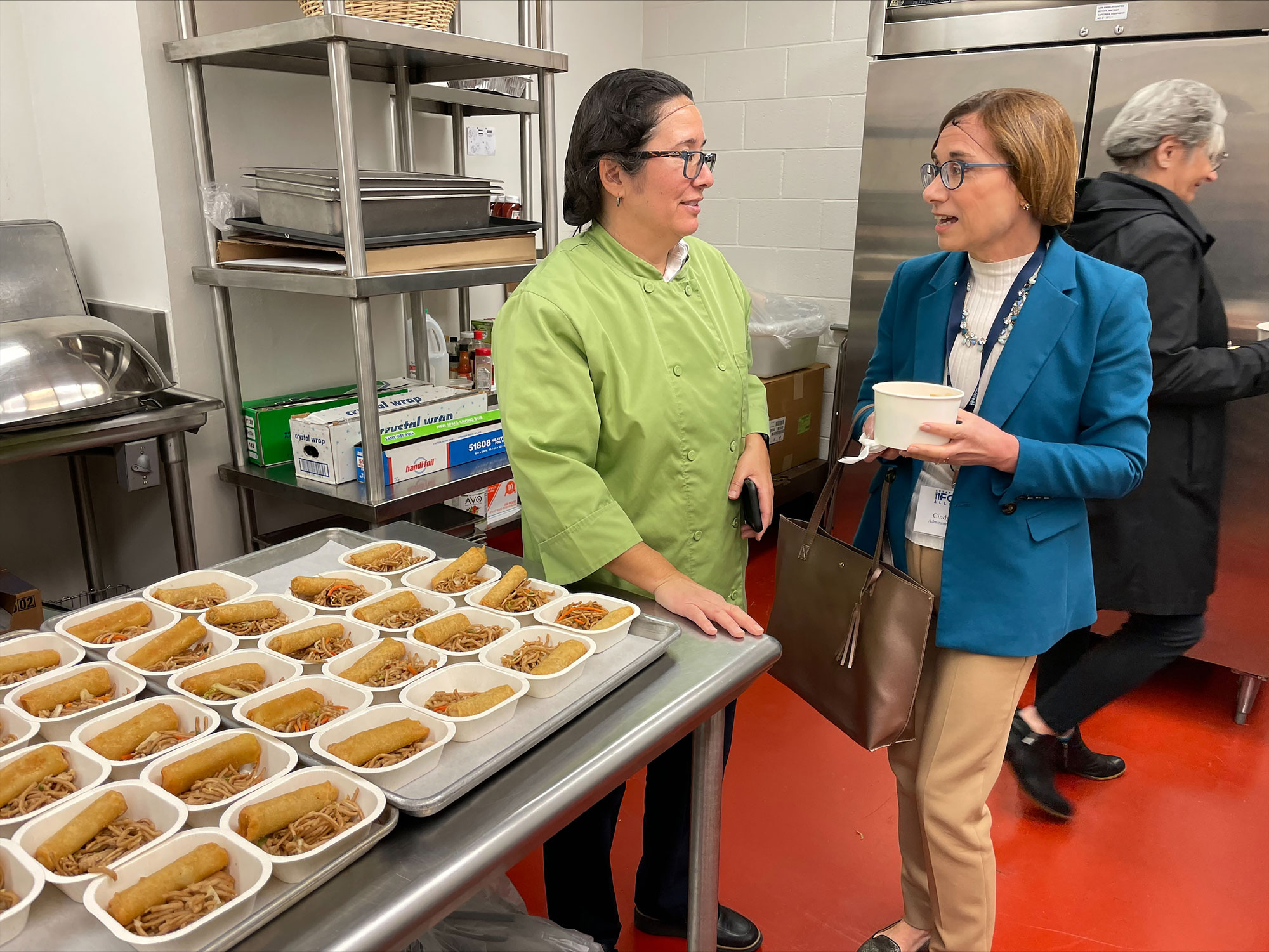 FNS Administrator Cindy Long speaks with Los Angeles Unified School District staff inside a school kitchen in Los Angeles, California
