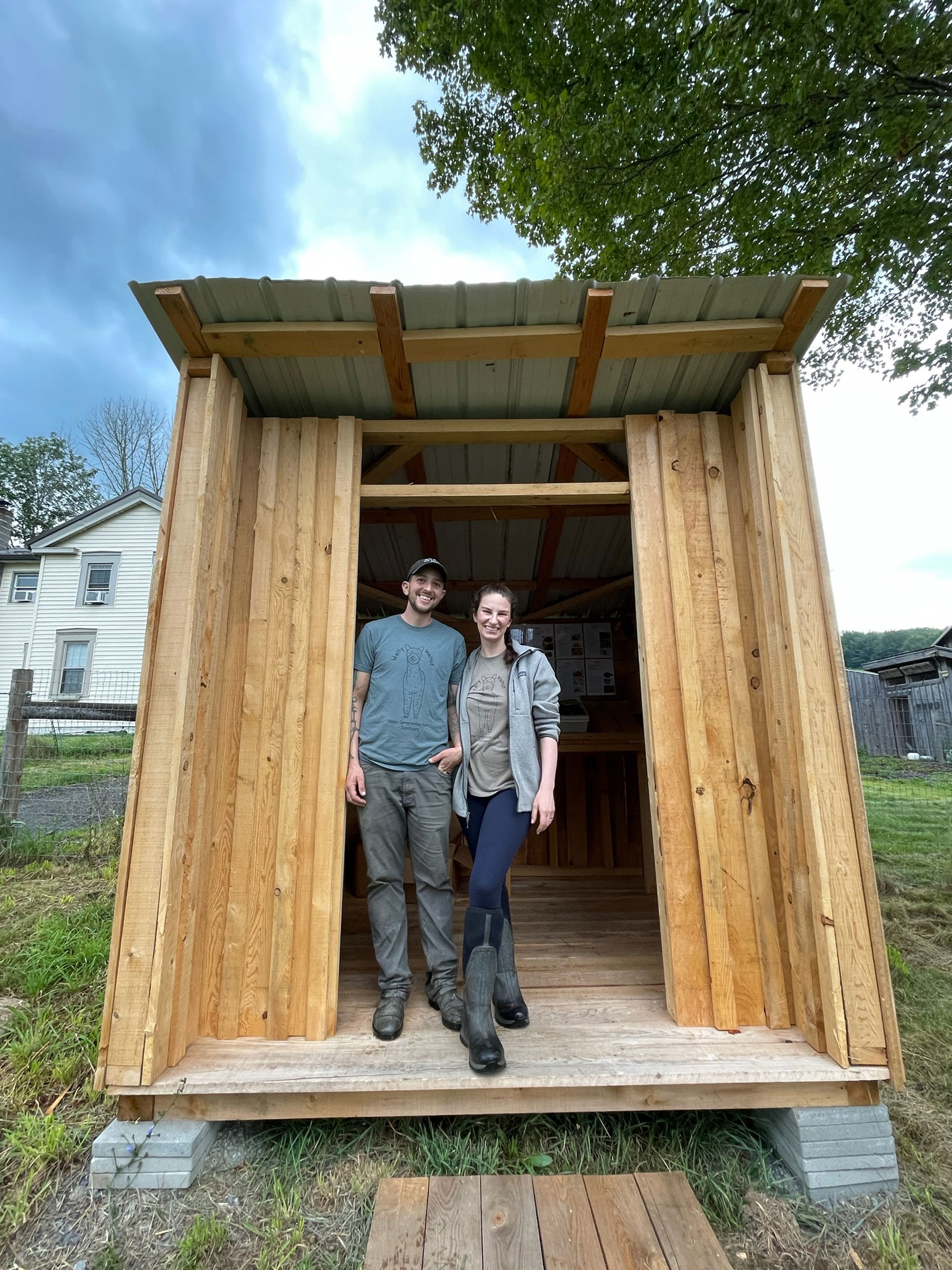 Oliver Gawlick and Eryn Leavens in the doorway of the new free farm stand they constructed for their community