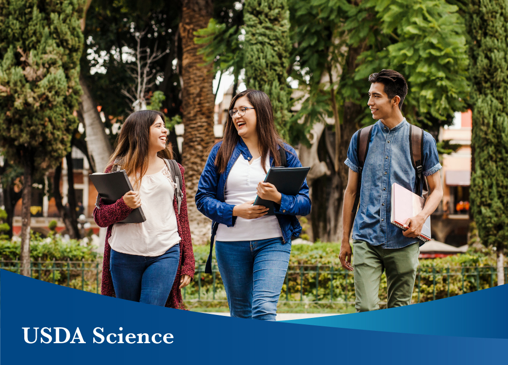 College students walking on campus carrying books. Image courtesy of Adobe Stock. 