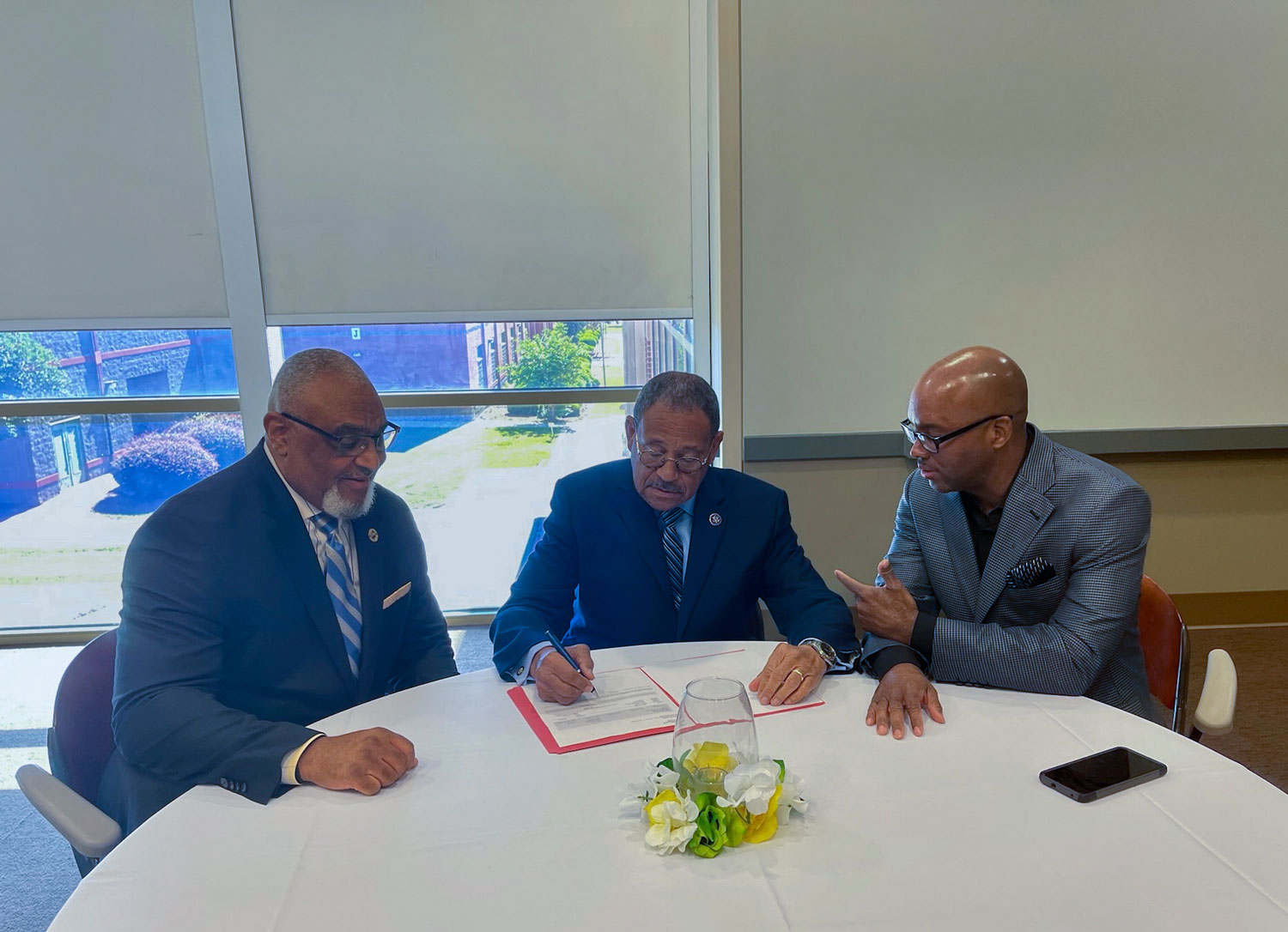 Acting Assistant Secretary Malcom Shorter, Congressman Sanford D. Bishop, Jr. and Executive Director Michael Hill sitting at table discussing the importance of collaboration to aid small businesses