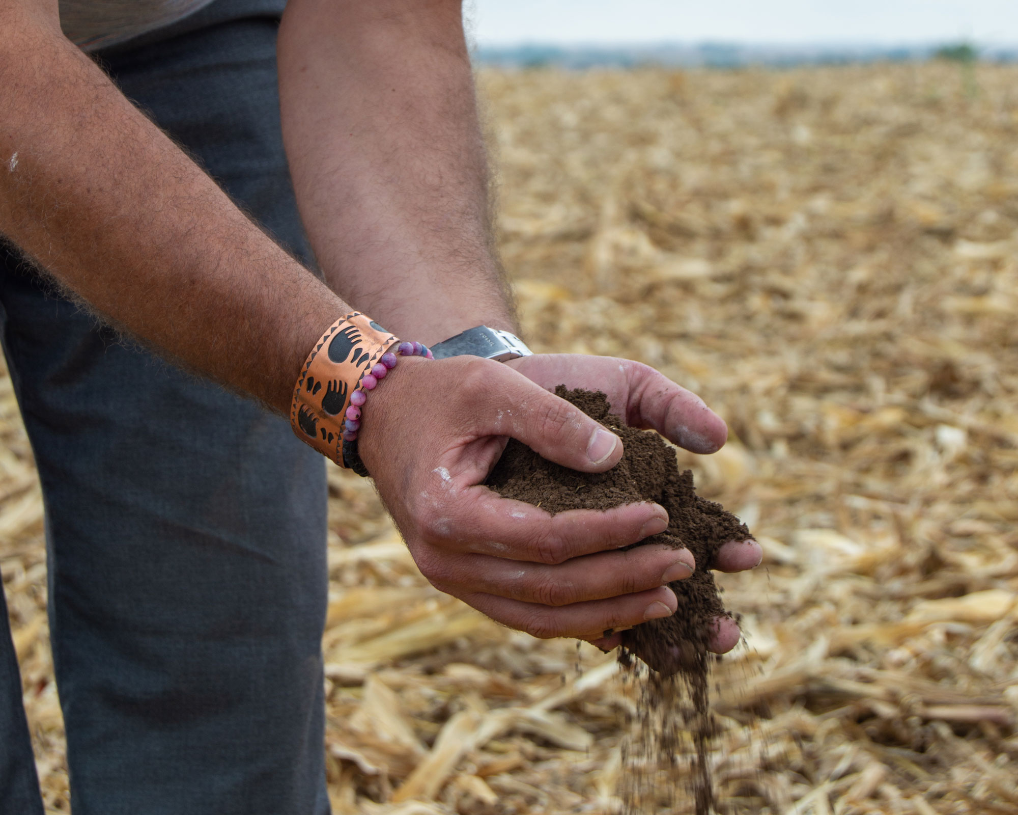 A person holding soil