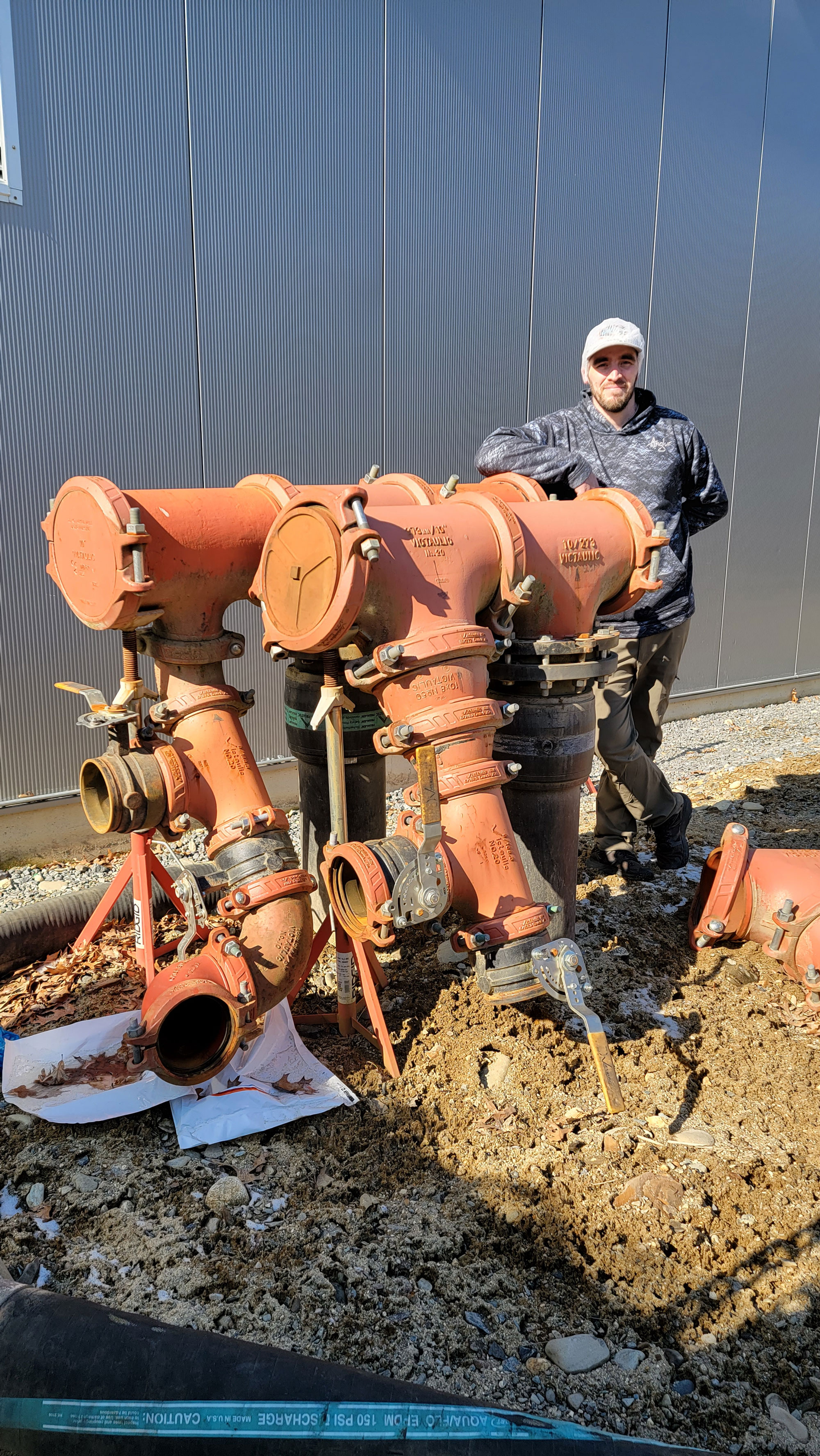 Maintenance Manager Steve Case for Little Leaf Farms in Massachusetts pictured next to input hookups for the greenhouse chiller