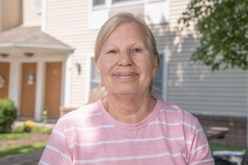 Carole Fosbaugh, a tenant living in a USDA-financed apartment, smiling at the camera