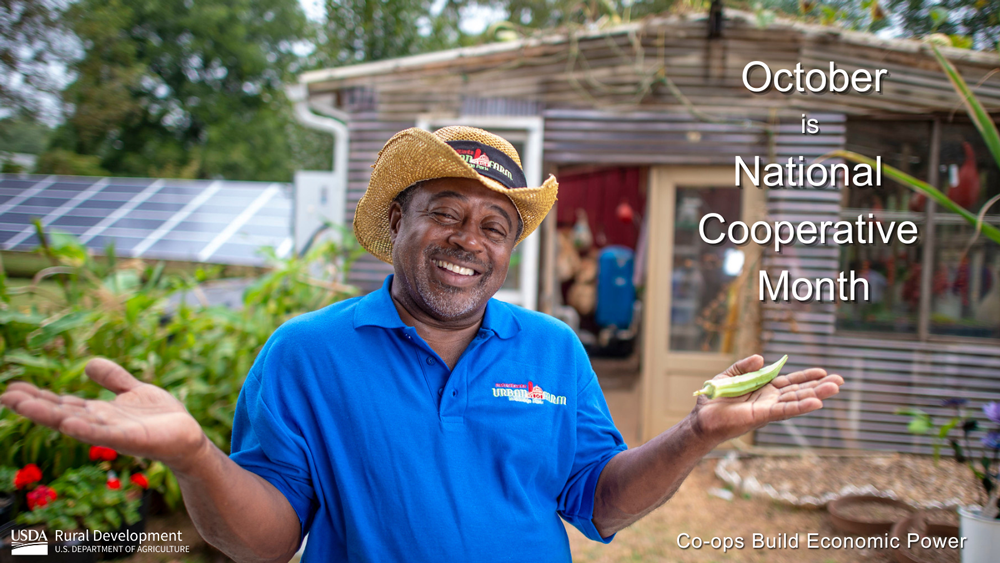 A man smiling with a house behind him and the October is National Cooperative Month text overlay
