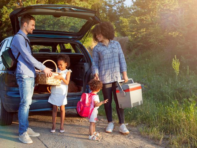 Family leaving car to have a picnic
