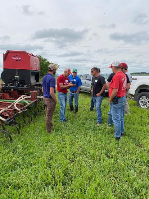 Scott Wedemeier shows farmers his summer cover crop seed mix, which he seeds after small grain harvest