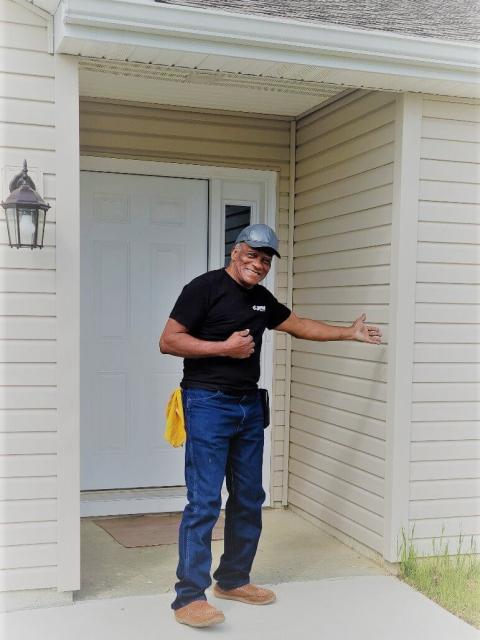 Richard Norman, homeowner and Mutual Self-Help Housing program participant, shows off his new house