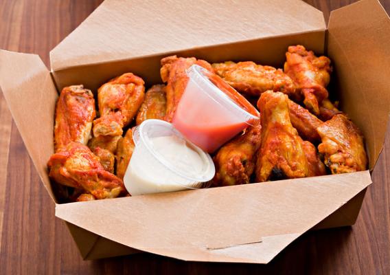A box of chicken wings and sauces