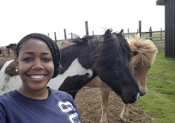 Author Brielle Wright in front of horses