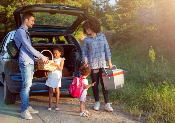 Family leaving car to have a picnic