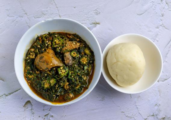 Okra soup served with fufu, a spongy dough made from boiled cassava and plantain