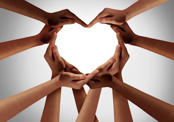 Ten hands coming together to form a heart