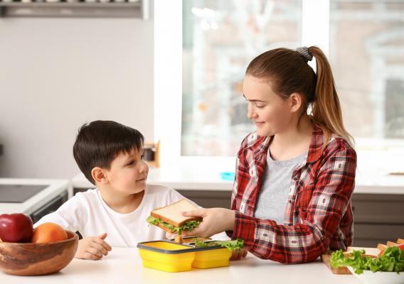 Mother prepares healthy meal for son