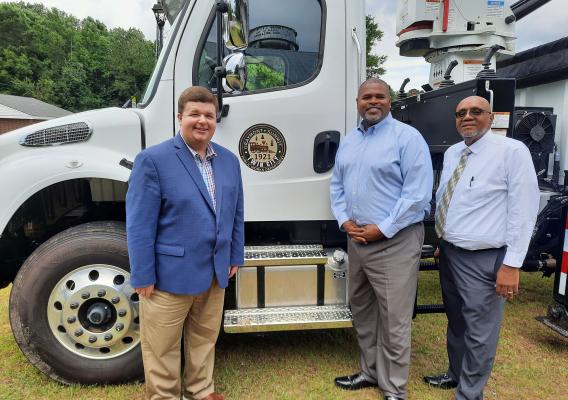 RD GA State Director standing in front of RD funded fire truck with Twin city mayor