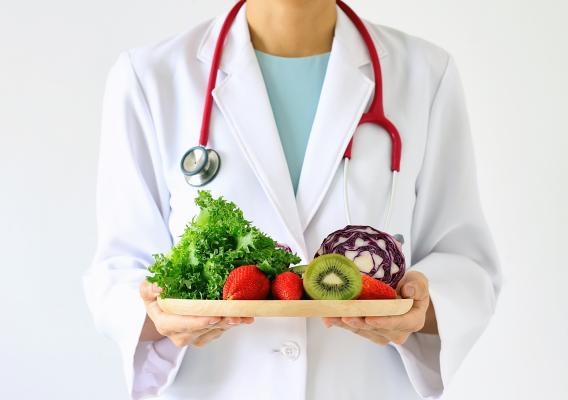 Doctor holding fresh fruit and vegetables