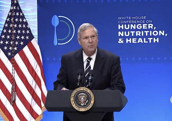 Agriculture Secretary Tom Vilsack speaking behind a podium at the White Conference on Hunger, Nutrition and Health at the Ronald Reagan Building in Washington, DC on September 28, 2022