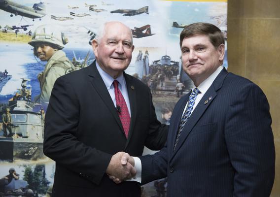 Secretary Sonny Perdue shaking hands with Larry Brom, the Director for Plans & Operations from the Vietnam War Commemoration