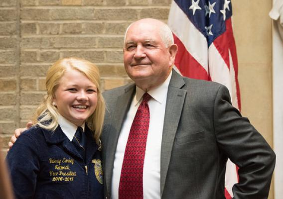 Valerie Earley poses with Secretary Perdue at the USDA Whitten Patio