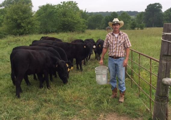 Military veteran, rancher, and National Agricultural Statistics Service data collection coordinator Lance Daugherty feeds his cattle over Memorial Day weekend