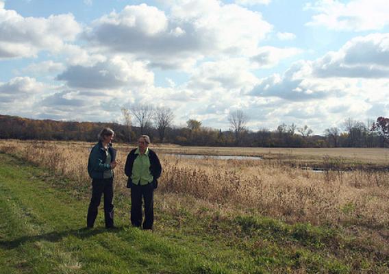 Left to right: NRCS biologist Kristin Westad visiting the wetland restoration area with landowner Elsbeth Fuchs on her Wisconsin farm
