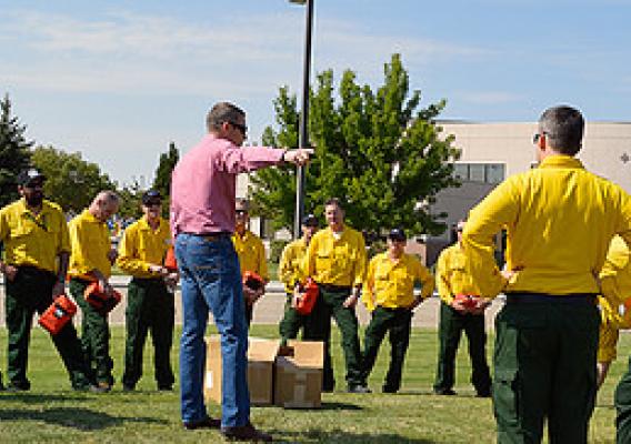 Australia and New Zealand fire managers are provided instruction prior to a practice fire shelter deployment